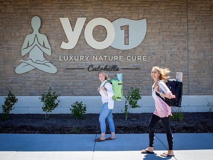 Yo1 signage in the background with 2 women walking