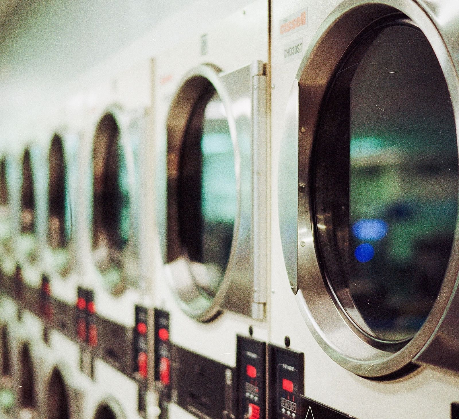 a number of washing machine placed in a row