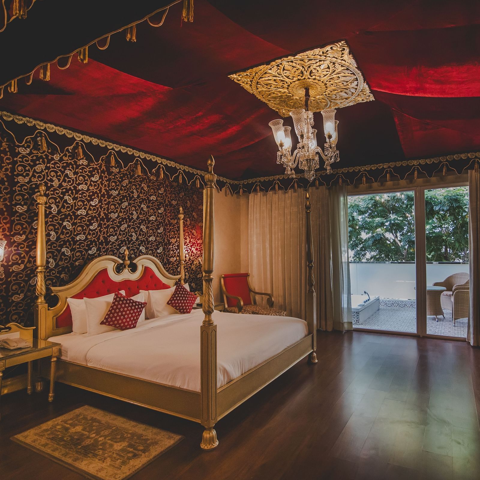 Image of a room with a bed and a chandelier above it at Rajasthali Resort & Spa Jaipur.