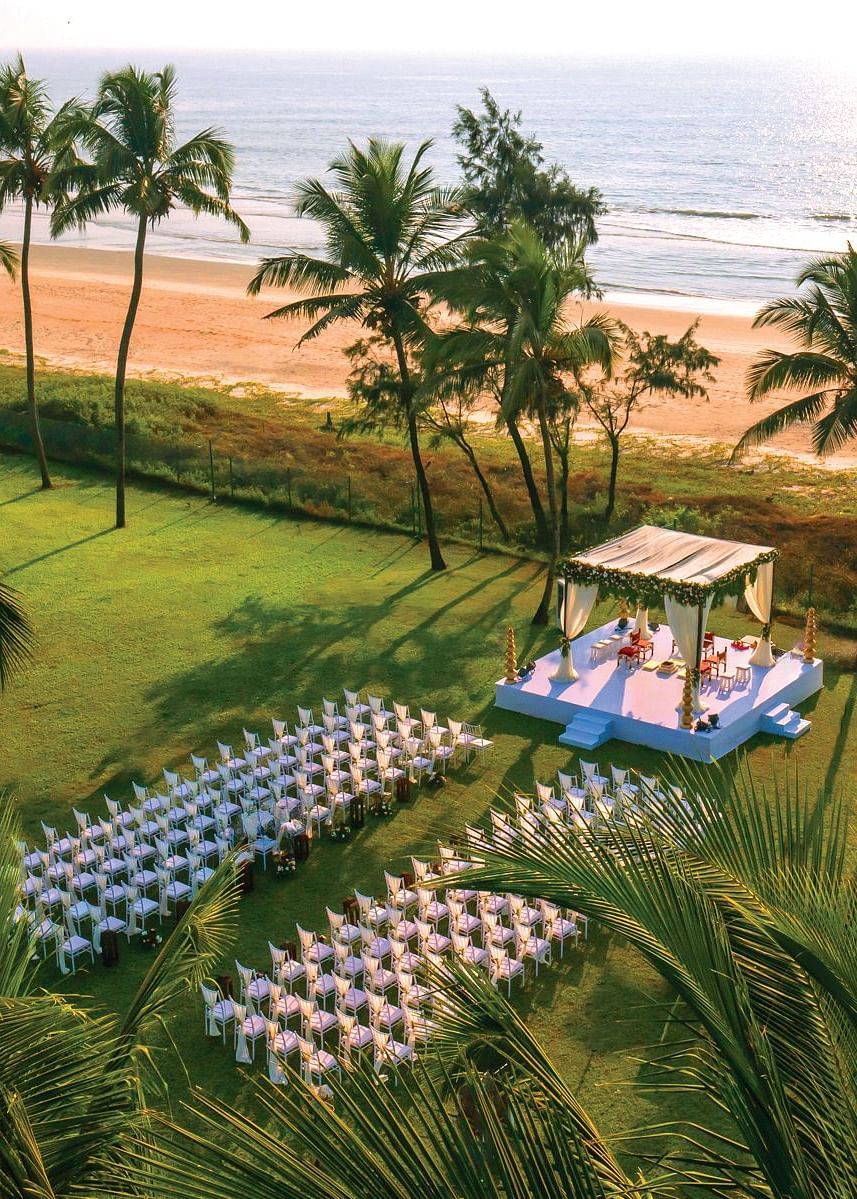 aerial view of a wedding with a stage and chairs in view - Caravela Beach Resort Goa