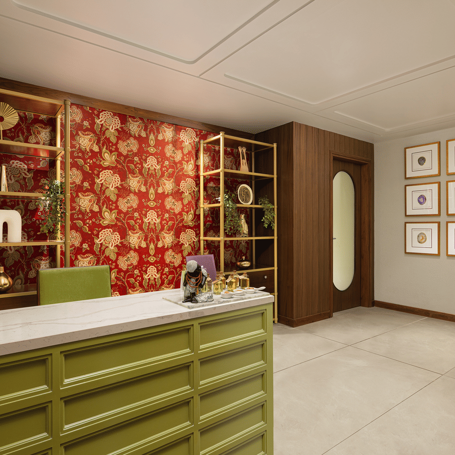 A luxury spa reception featuring an olive green desk, gold shelving, and a vibrant red floral wallpaper backdrop.
