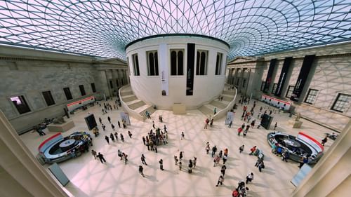 A 270 degree view of a museum with people moving around in the empty space