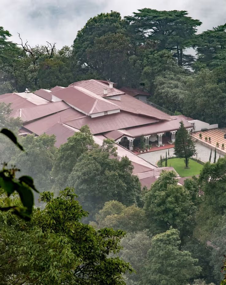aerial view shot of The Claridges Nabha Residence in Mussoorie surrounded by lush green forest