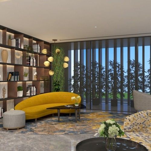 Sofa next to a showcase with books and vases - Golden Tulip Bhopal