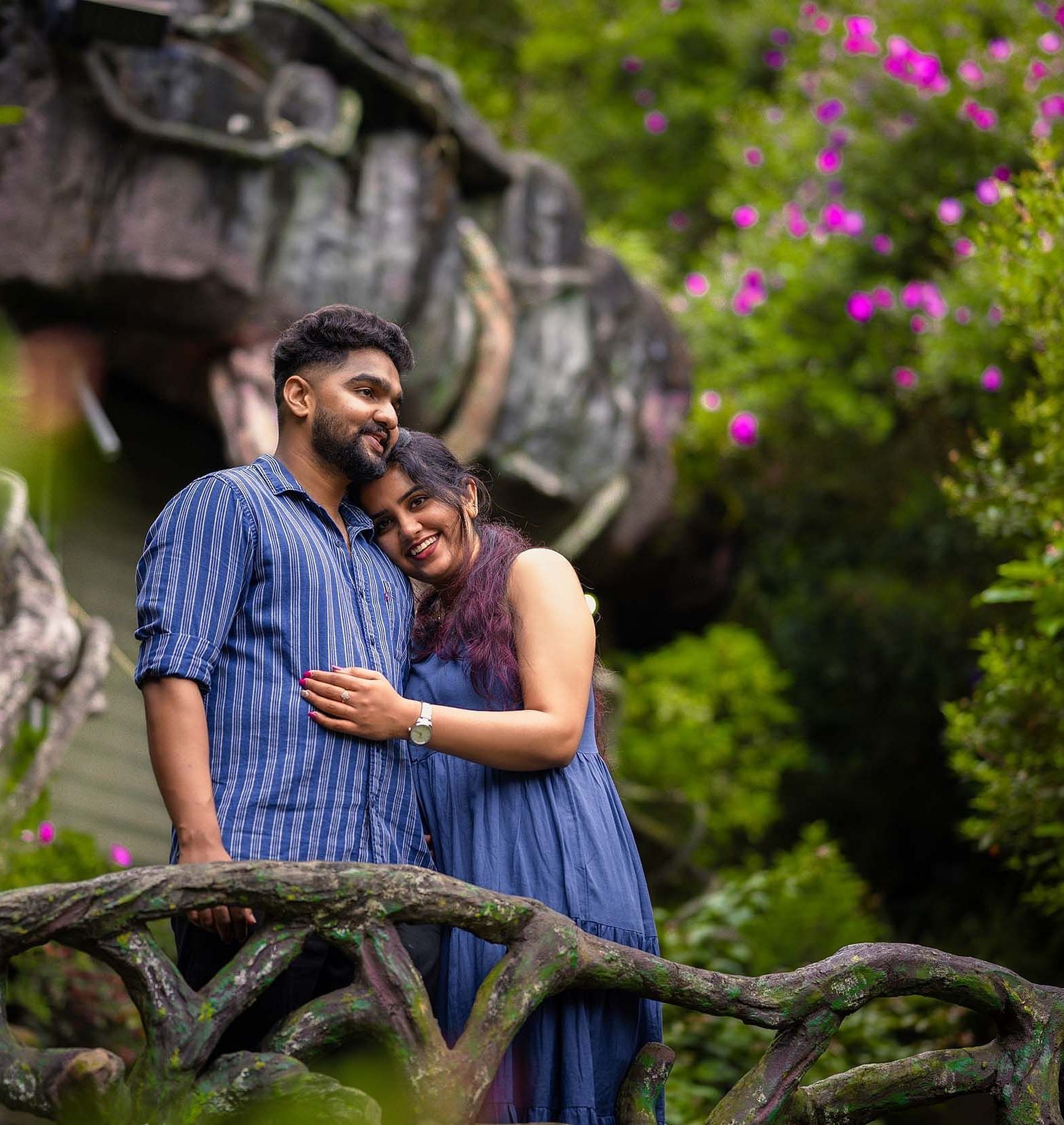 a couple in a scenic place with greenary and violet flowers