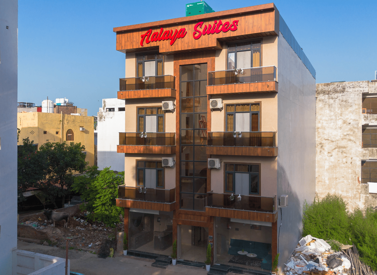 Exterior view of the multi-storey hotel building with 'Aalaya Suites' written on top under a bright blue sky - Perfectstayz Value Aalaya Suites, Haridwar