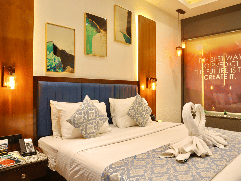 Skyline by Miraya, Classic Room, Bed framed by wall sconces and artwork