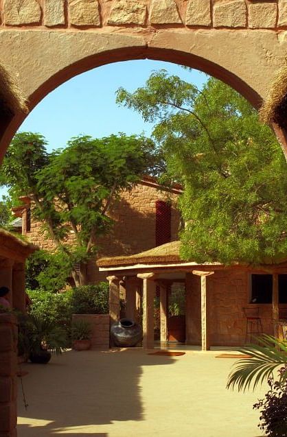 An image of an entrance to the resort with lush greenery - MANVAR Resort & Desert Camp