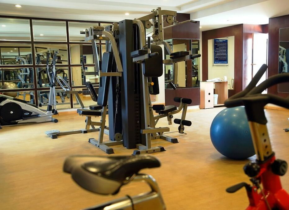 A gym filled with various equipment and bright lighting | Cenneys Gateway