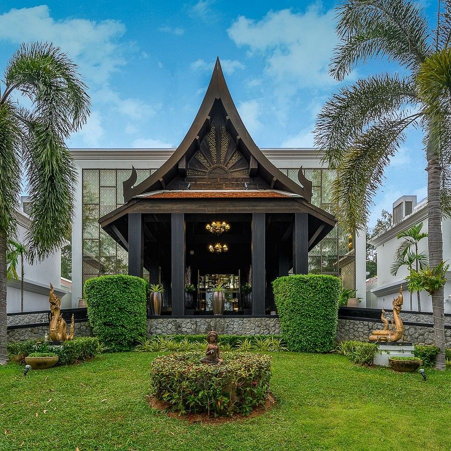 alt-text image of the entrance with a serene green lawn in the foreground - Maikhao Dream Villa Resort & Spa, Phuket
