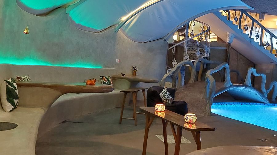 Stylish poolside lounge with a unique, curved architectural feature - Matsya Island.