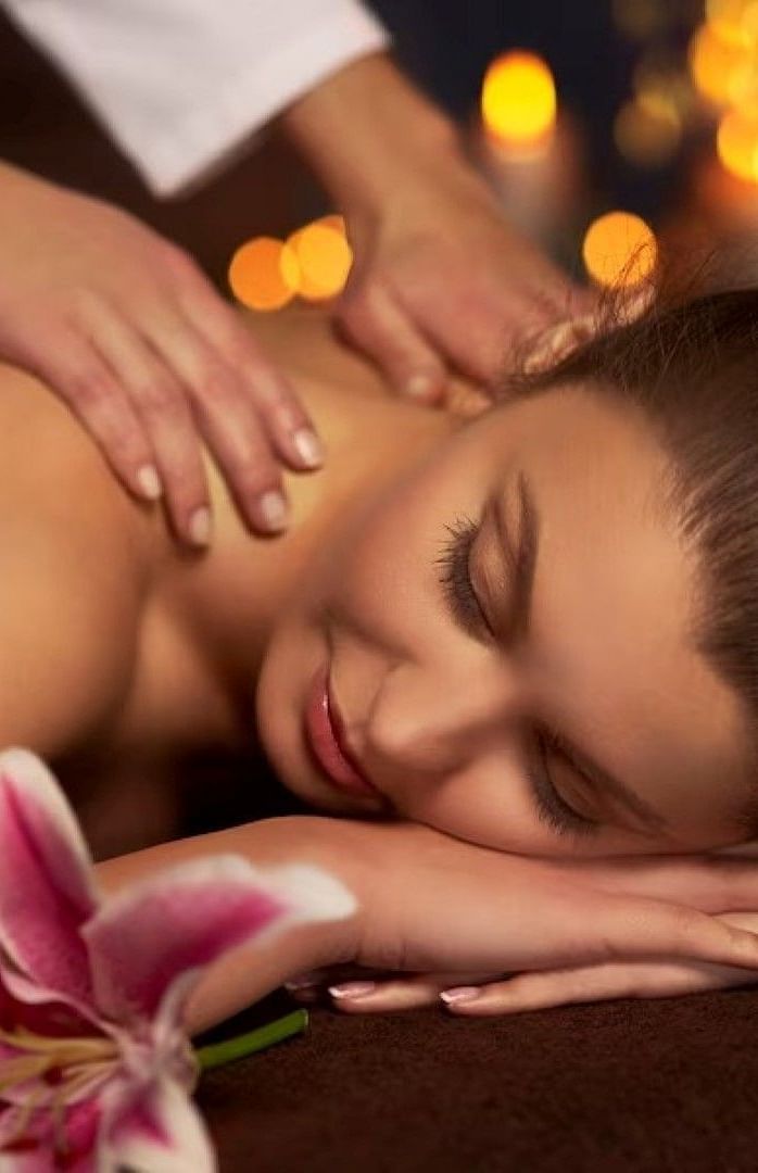 A woman reclining on the spa bed for a massage