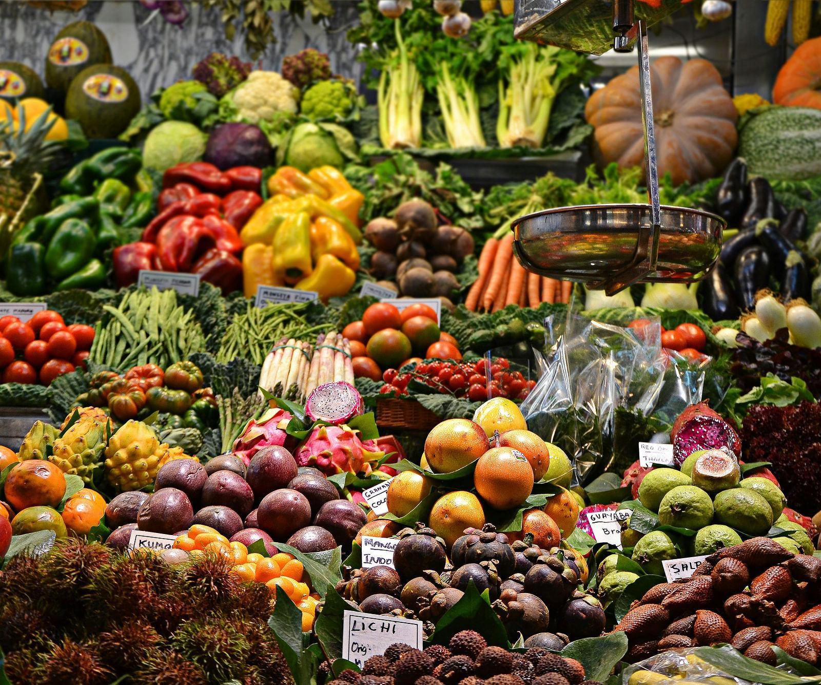 a close up shot of a shop selling fruits and veggies that are kept on a table