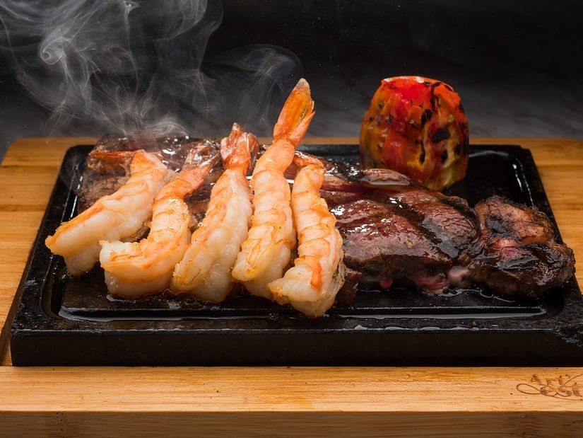 An image of a steaming hot dish made of prawns and steak - S Hotel Montego Bay, Jamaica