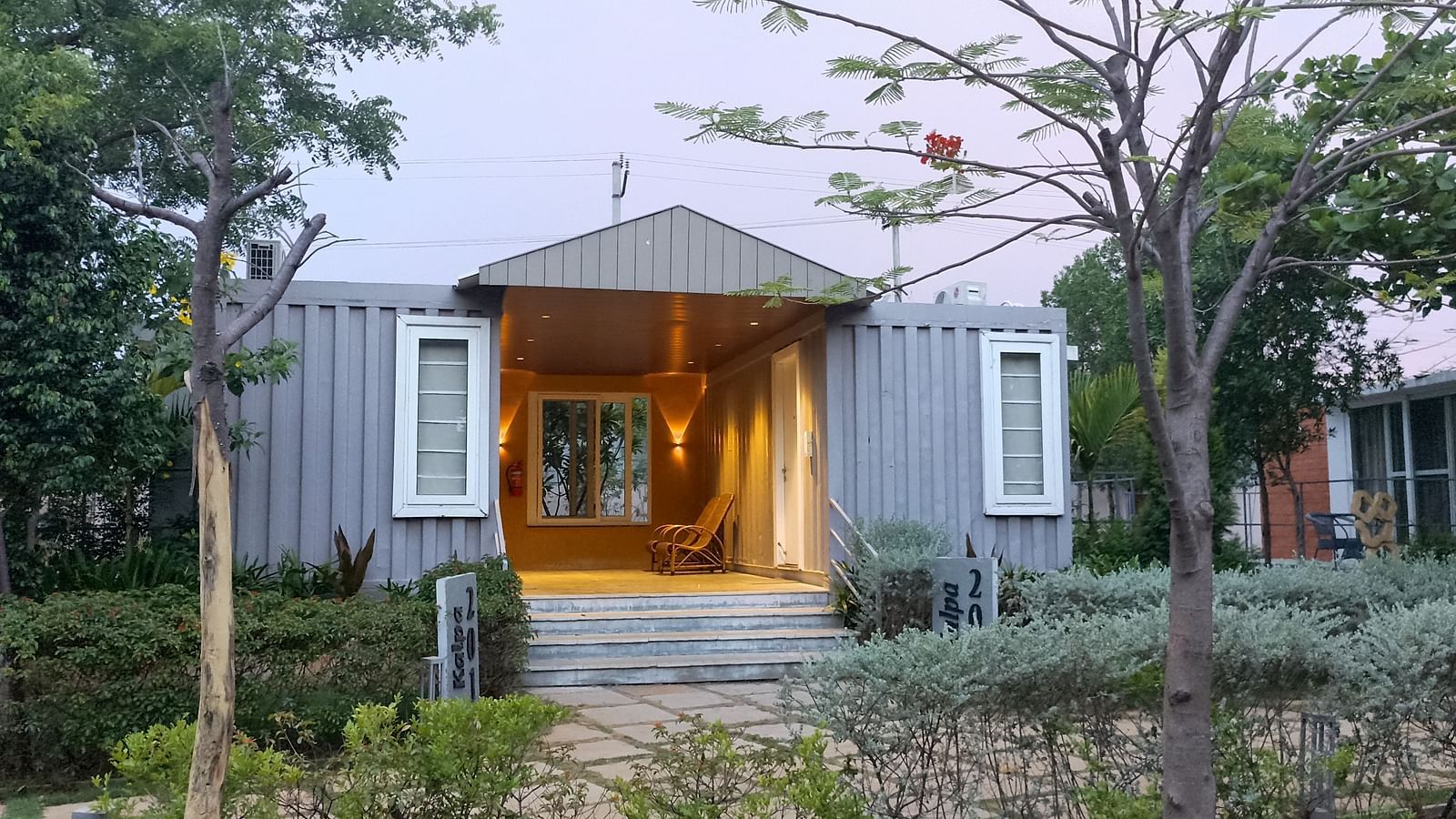 A facade image of the Kalpa cottage with greenery around - Trance Veechika Resort