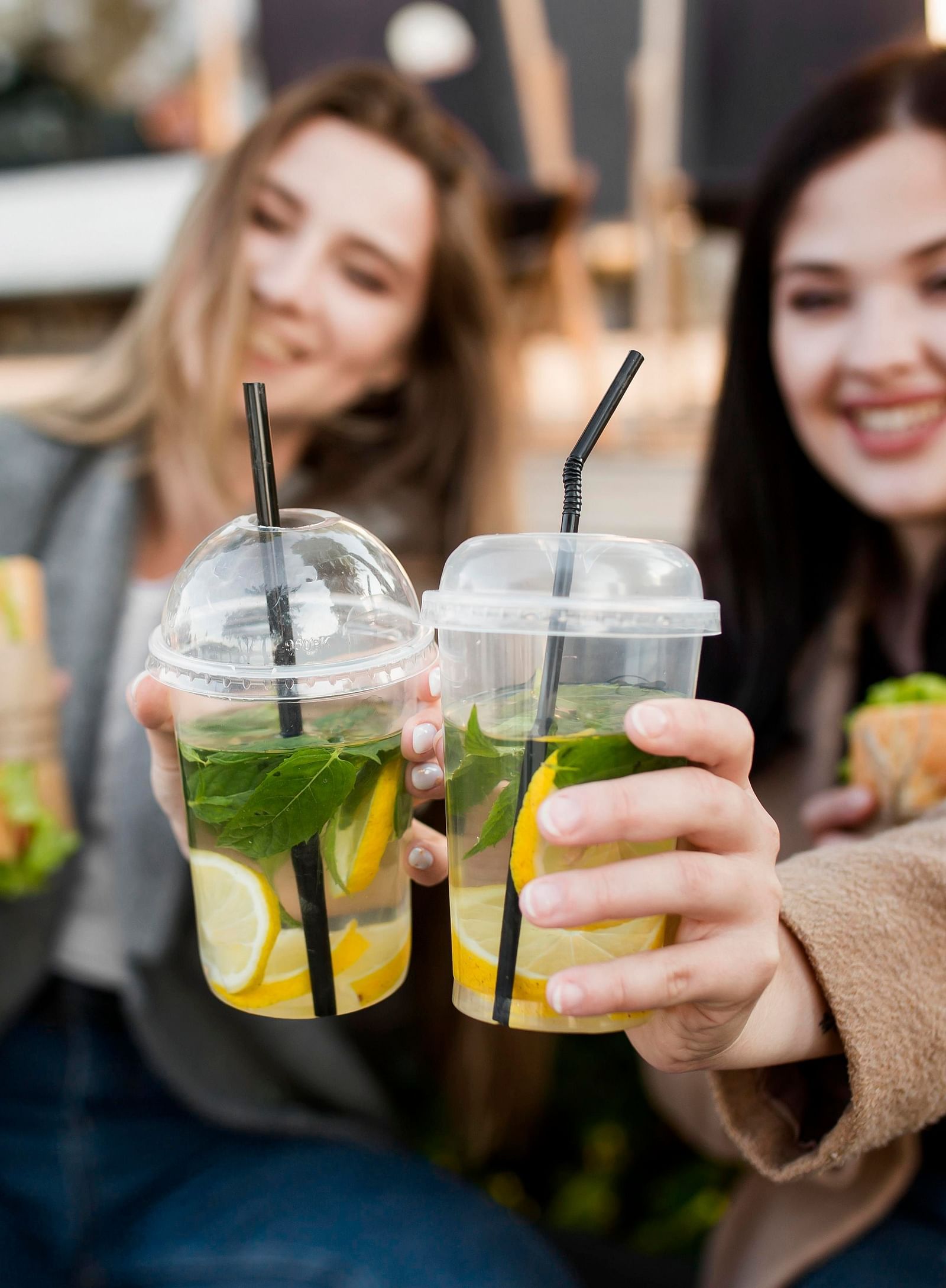 front-view-young-women-enjoying-some-subs-cocktails