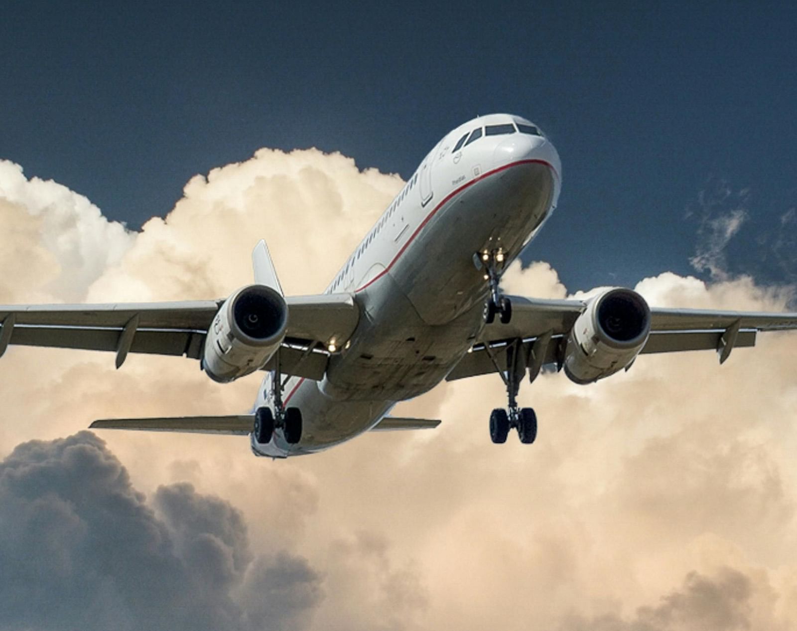 An aeroplane soaring through a heavily clouded sky