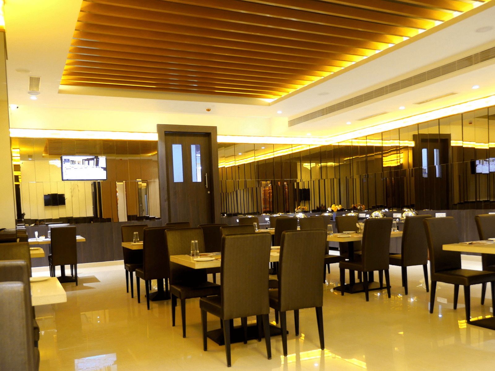 dining space of the restaurant Spice Treat with warm lights at ASR Parklane, Hosur
