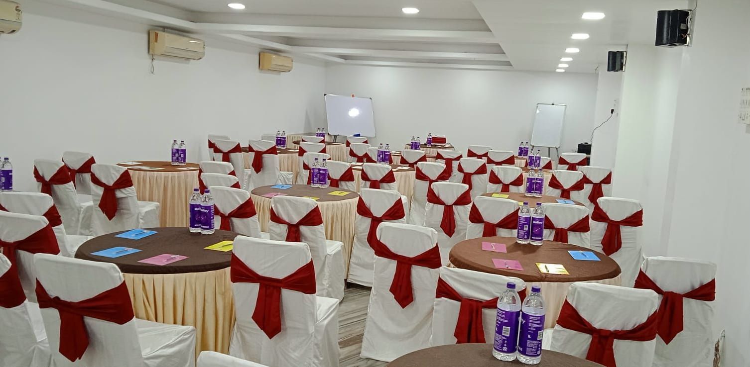 Round tables and chairs covered with cloth, and warm overhead lighting enhance and reside in the Emerald banquet hall of Mountview Resort.