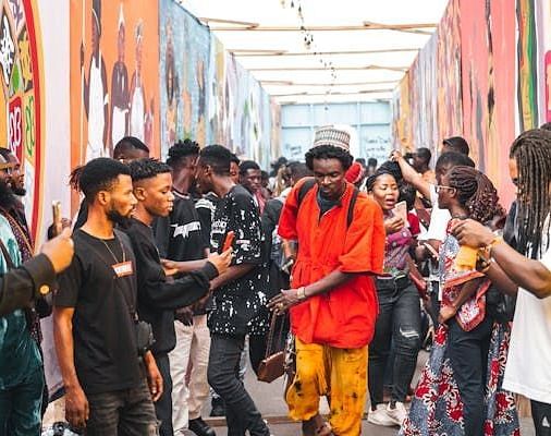 Vibrant street scene with youth gathered in a graffiti-adorned alleyway, showcasing the city's creative urban culture.