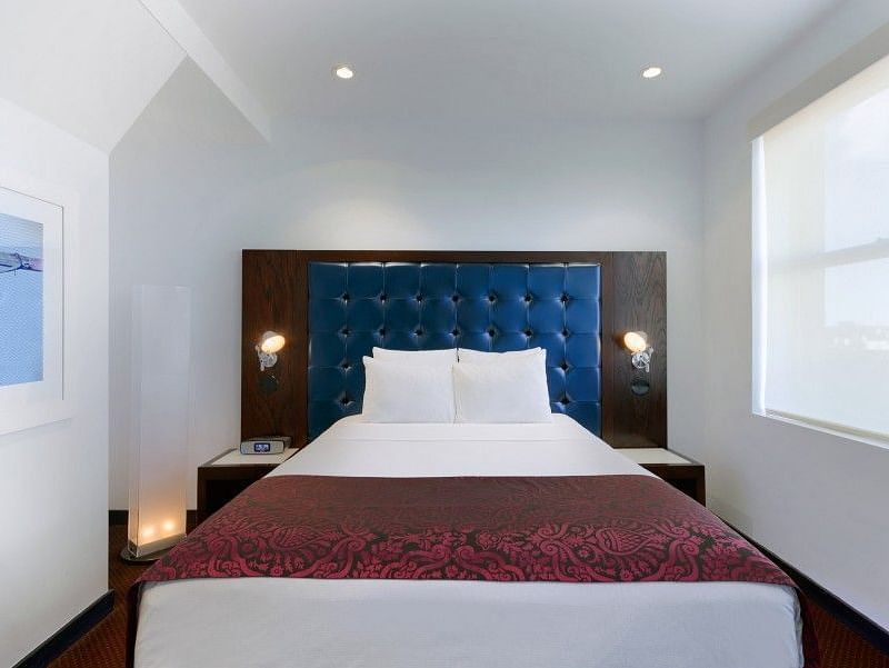 A large room with a bed and a window that overlooks the surroundings