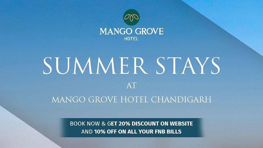 A promotional image for Mango Grove Hotel Chandigarh featuring its summer stay offer. The image showcases the hotel's exterior with a clear blue sky. The text highlights a special promotion: 20% discount on bookings made via the website and 10% off on all 
