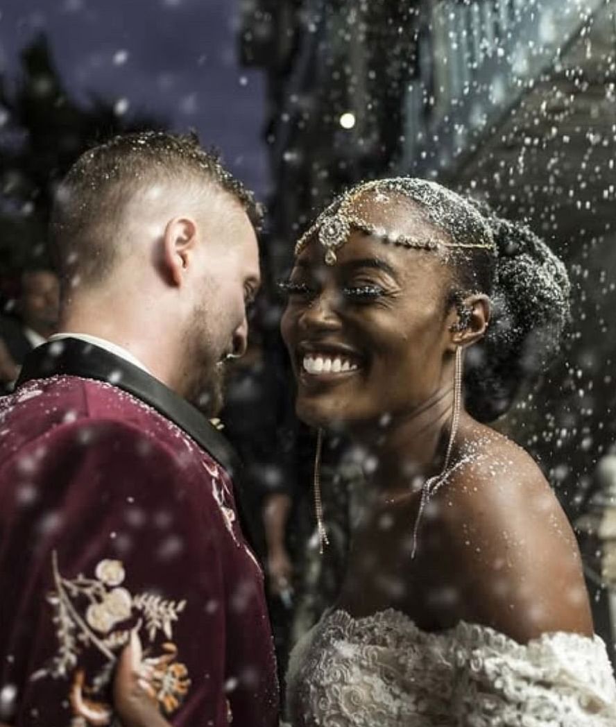 A couple smiling during wedding celebration with confetti in the air | A Stone's Throw Away