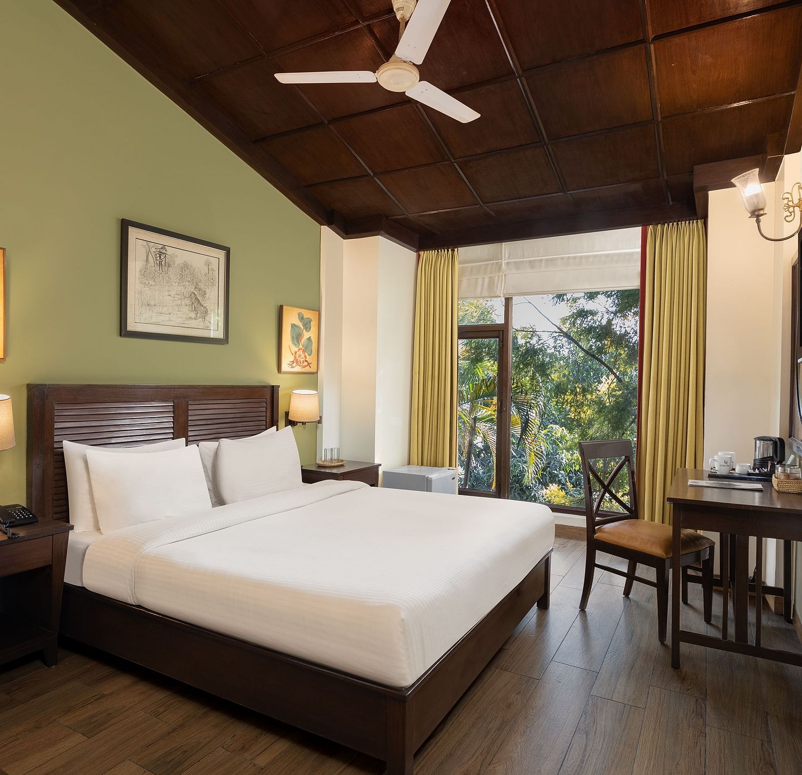 An image of a bedroom with double size bed, frames hanged on the wall, flat TV screen, work desk with chair, and a fan on the ceiling - The Riverview Retreat, Corbett