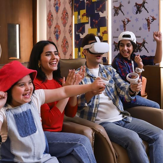 A family of four having fun while the father is on a VR headset - Heritage Village Resorts & Spa, Manesar