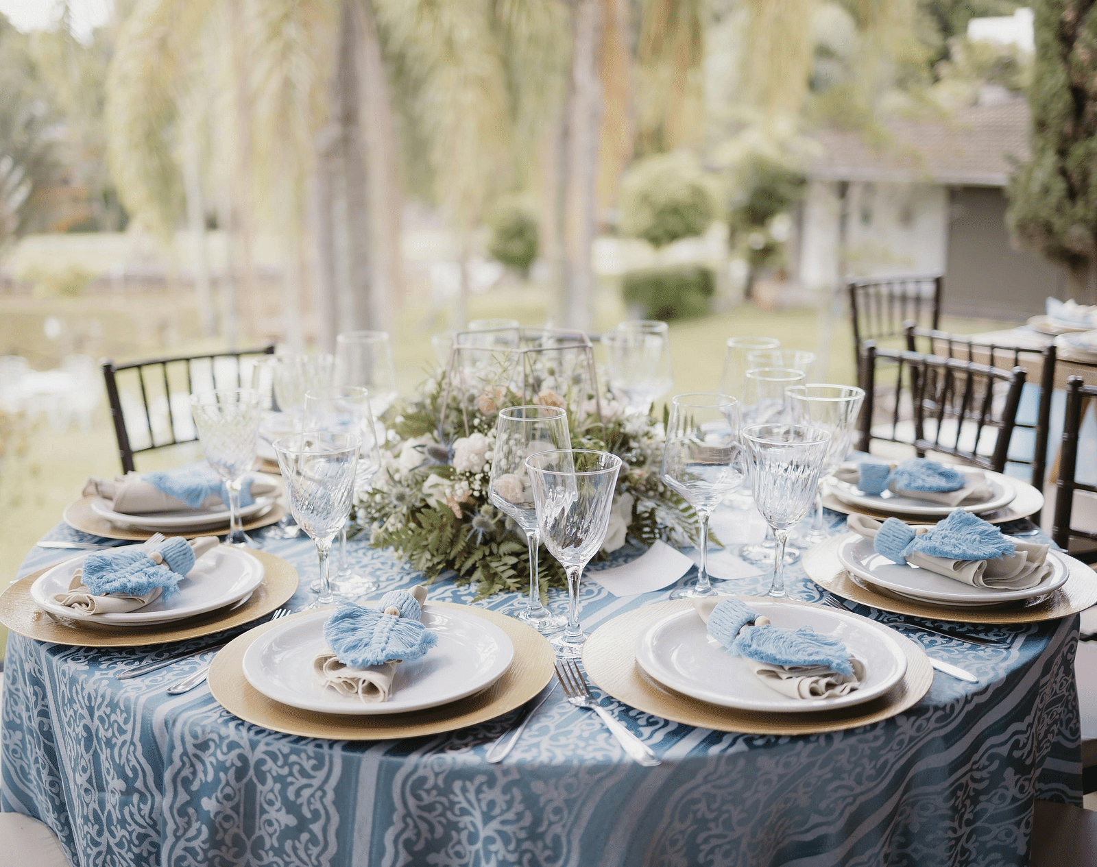 A beautifully arranged table and chairs, adorned for an event.