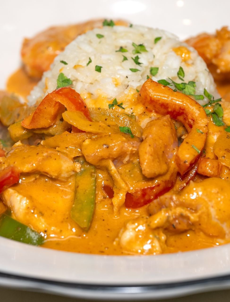 A close up of seafood with fluffy rice and a creamy sauce served at The Tallman Hotel