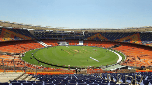  A view of the cricket stadium from the top-tier seating, capturing the entire field and atmosphere below.