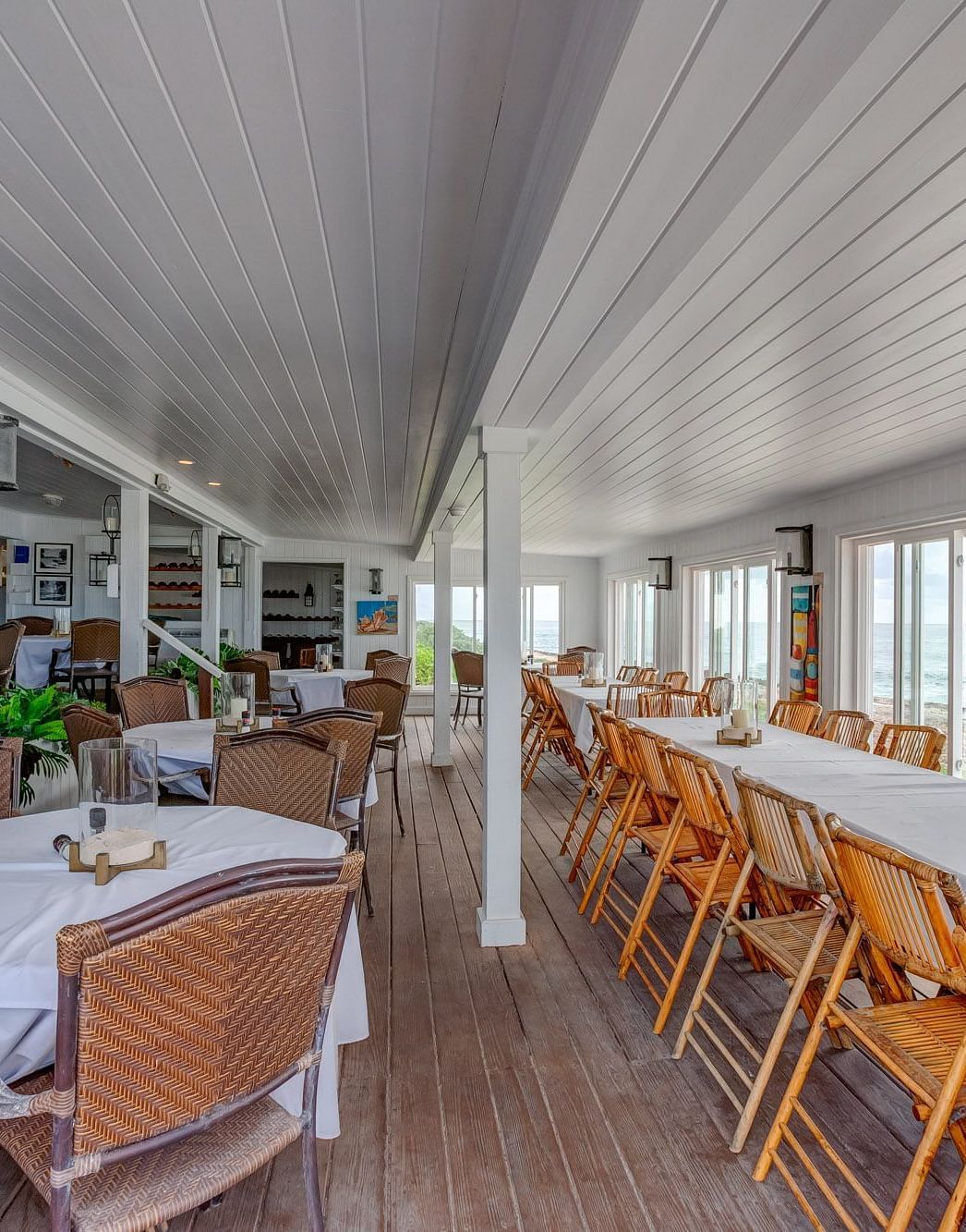 Indoor restaurant with white ceiling and wooden furniture | Abaco Inn