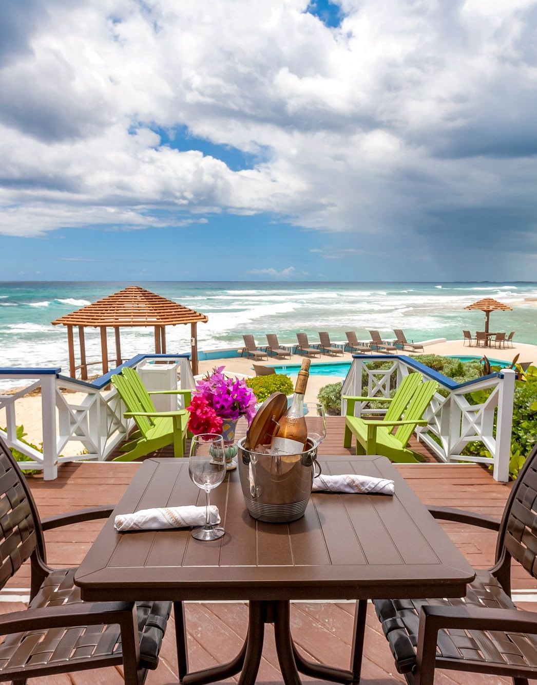 Table with drinks and flowers facing the ocean | Abaco Inn