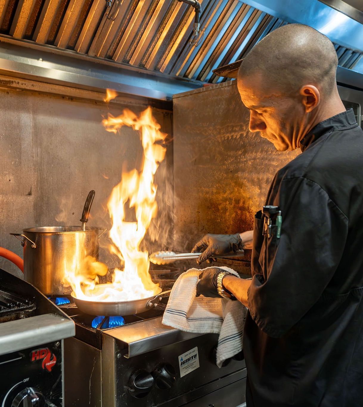 A chef cooking at the station in a commercial kitchen