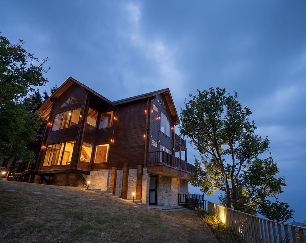 cottage with lights in the evening and blue skies | Avalon Cottages, Kanatal