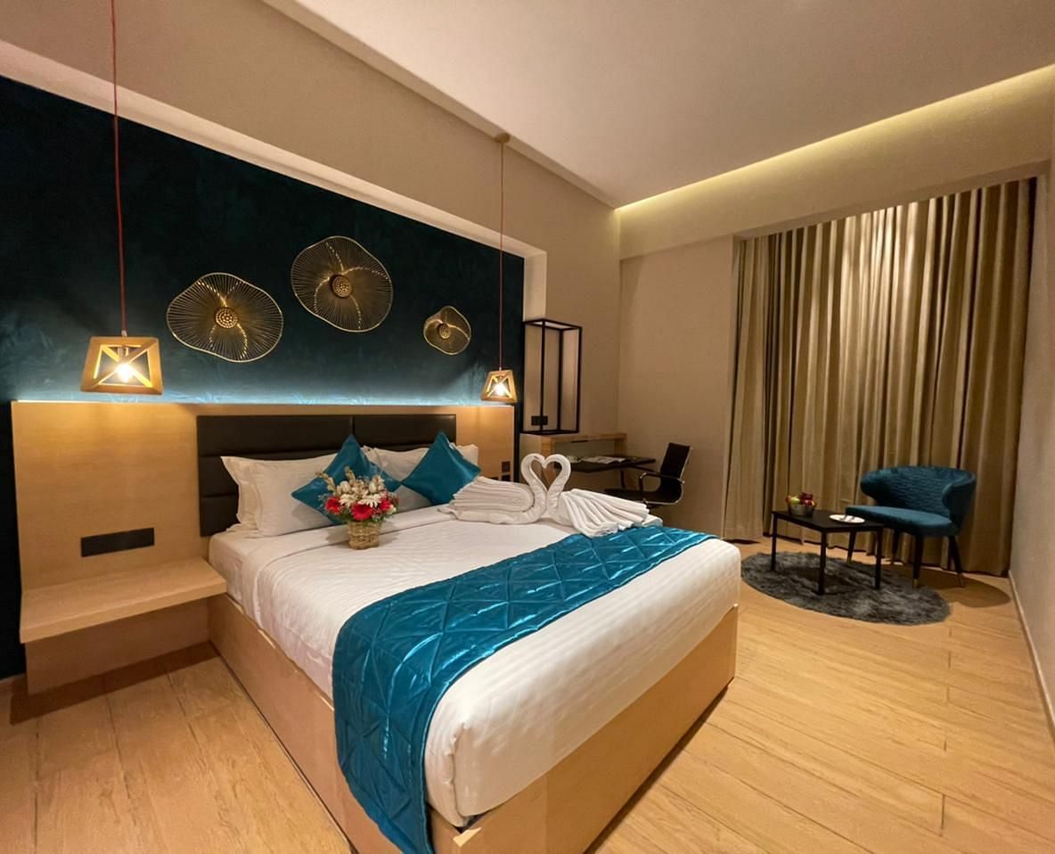Double bed with blue sheets at Premium Room at Le Foliage by TGI, Bangalore