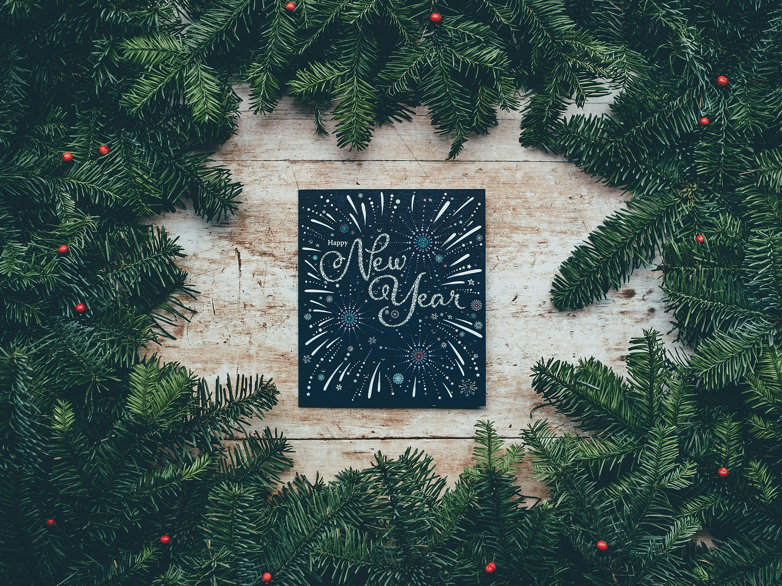 Festive holiday message surrounded by green Christmas garland