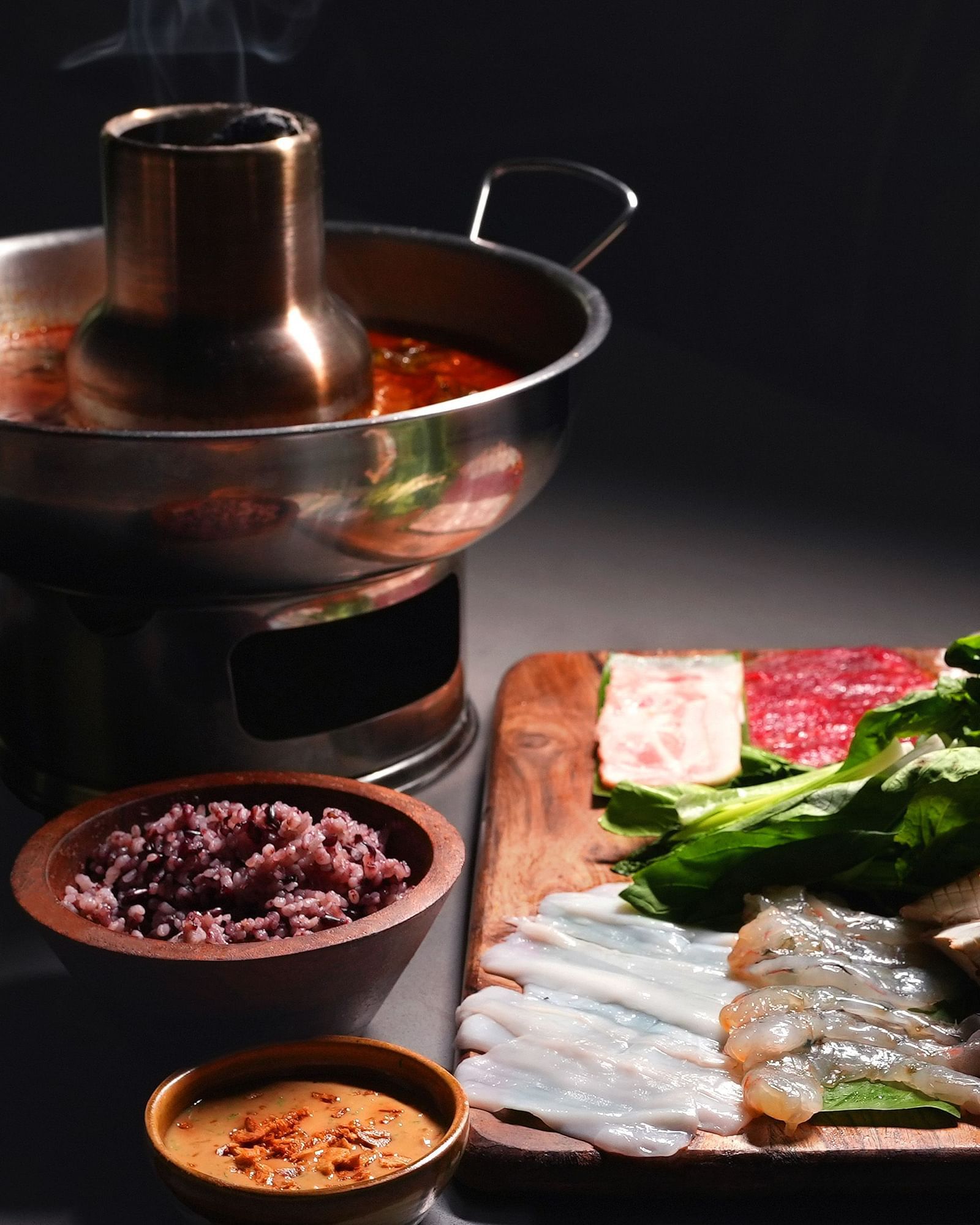 hot pot dish with assorted meat and condiments