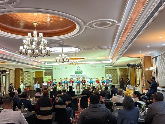 A cultural performance at the Bengal MICE Conclave, with traditional dancers on stage and a business audience in an elegant banquet hall.