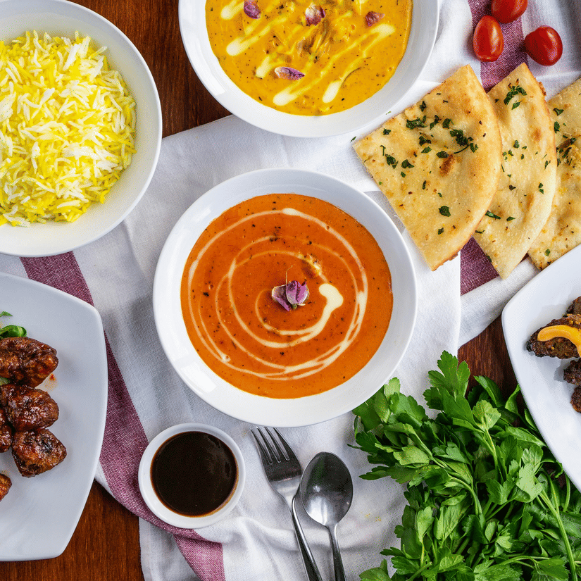A top shot of a delicious spread of various Indian dishes served on a table.