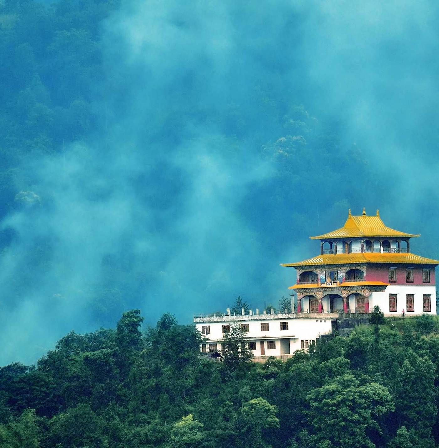 a temple atop a mist-shrouded hill in gangtok