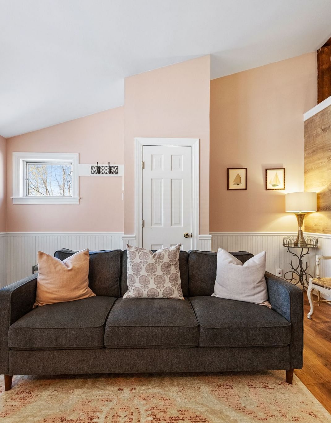 A room with a sitting area, designed cushions, and cozy lighting at Hartstone Inn