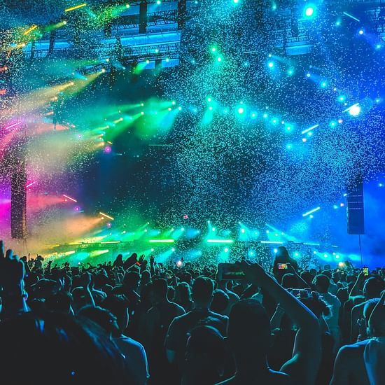 Concert night, pink, yellow,blue and green lights lighting up the stage