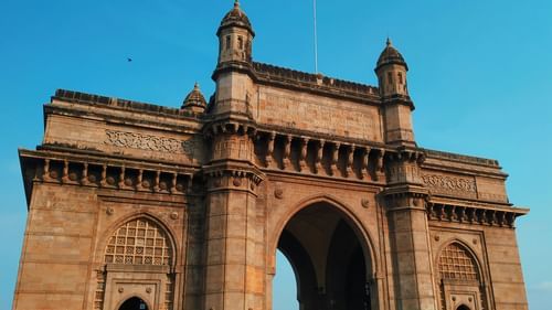 Gateway of India archway under a blue sky.