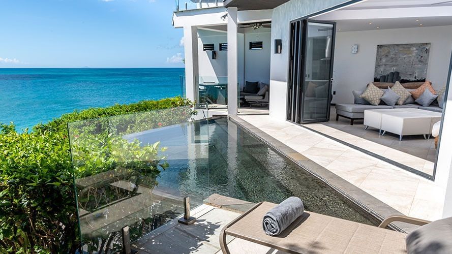 Private villa with ocean-facing plunge pool and sun loungers at Tamarind Hills Antigua – Resort & Villas