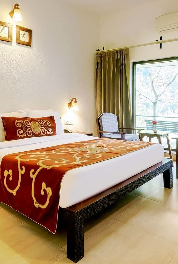 Image of a room with bed and large windows at Summit By The Ganges Beach Resort & Spa, Rishikesh