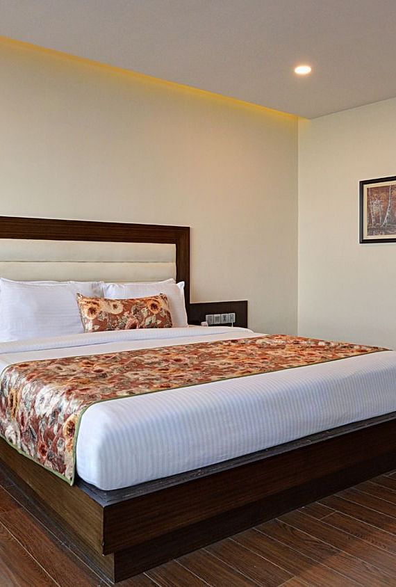 Junior Suite View Room with spacious bed, sofas, bed side table