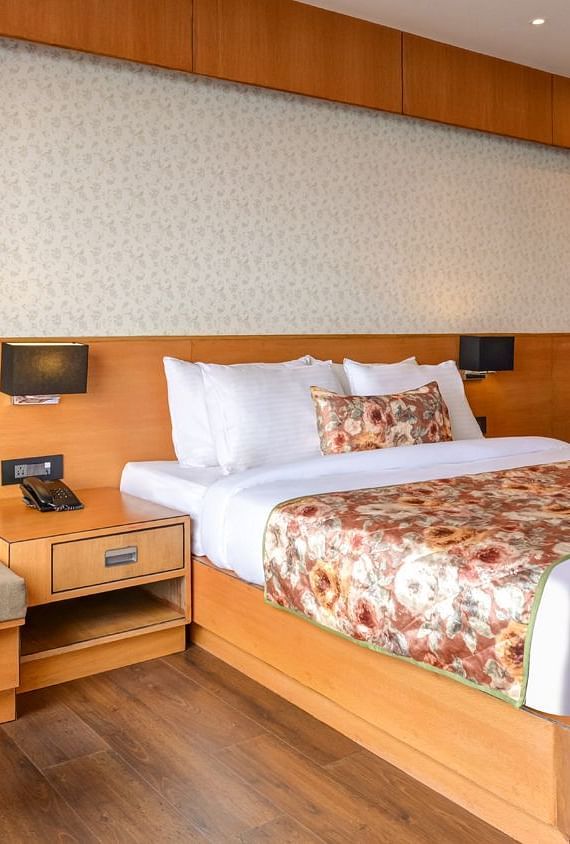 Presidential Suite with spacious twin beds and wall mounted televison along with large windows