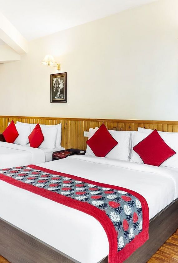 A side view of two beds in a room | Summit Newa Regency & Spa, Pelling